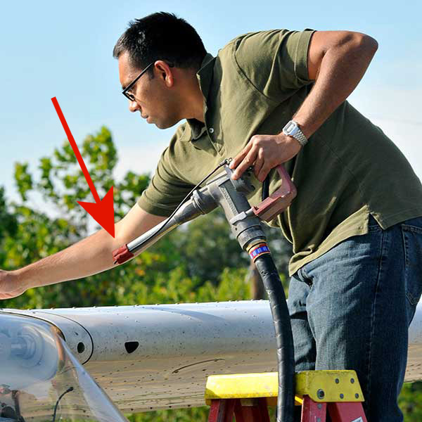 pilot places fuel cap on nozzle when done fueling